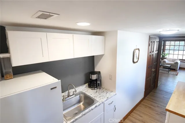 a kitchen with a refrigerator and a stove top oven