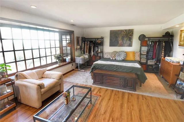 a bedroom with furniture and a large window
