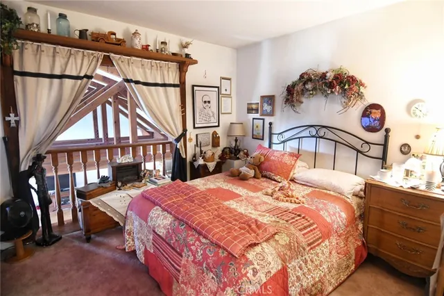 a bedroom with bed and a chandelier