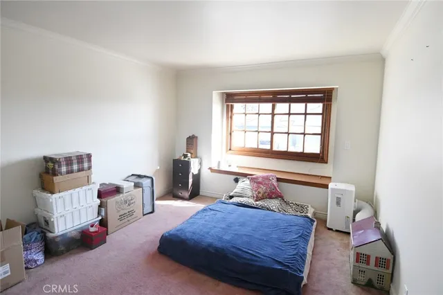 a bedroom with bed and a window