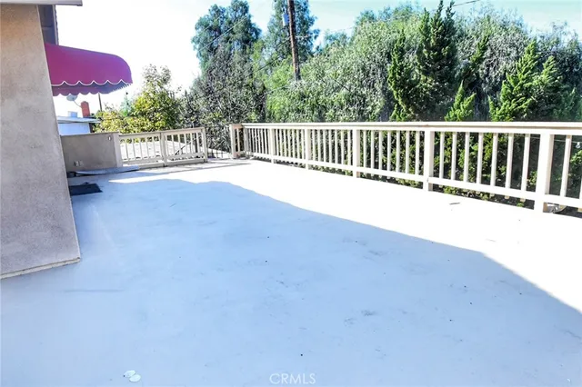 a view of balcony with wooden floor