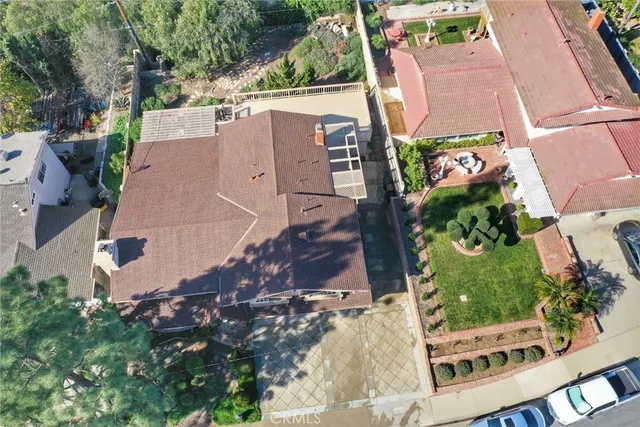 an aerial view of a house with a yard
