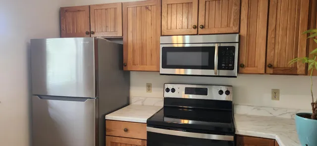 a kitchen with appliances and cabinets