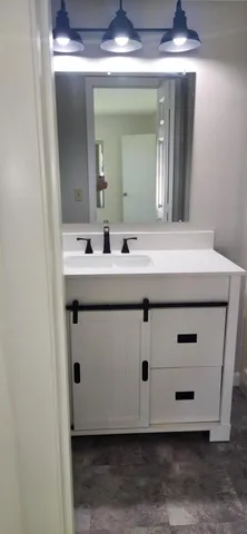 a bathroom with a sink and a mirror