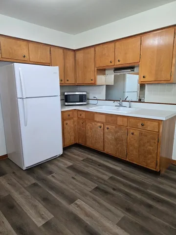 a kitchen with stainless steel appliances granite countertop a refrigerator a sink and a stove