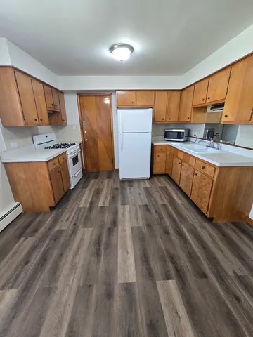 a kitchen with stainless steel appliances granite countertop a stove a sink and a refrigerator