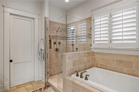 a bathroom with a bathtub and shower