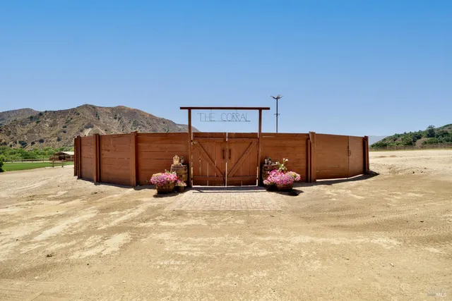 a view of a house with a yard and sitting area