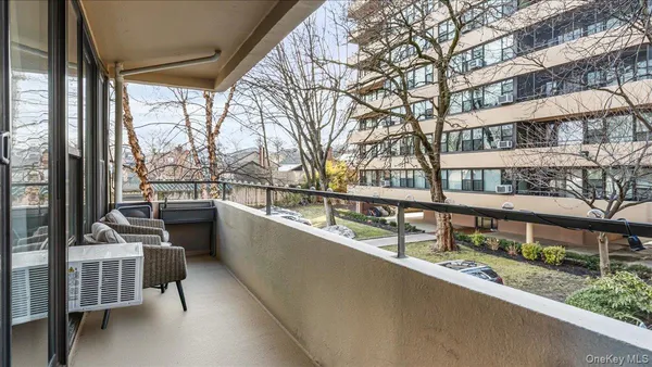 a living room with furniture and a view of kitchen