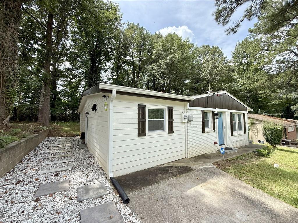 3188 Delmar Lane Northwest Atlanta, GA 30311 - Photo 1 of 16 a front view of a house with a yard