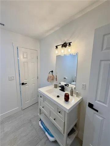 a white house with sink and mirror