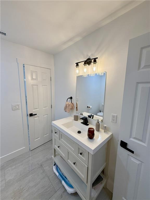 3188 Delmar Lane Northwest Atlanta, GA 30311 - Photo 11 of 16 a white house with sink and mirror