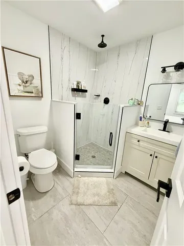 a bathroom with a toilet sink and shower
