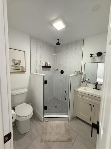 a bathroom with a toilet sink and shower