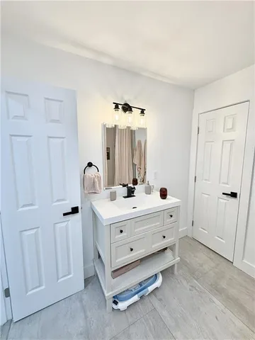 a room with a bed and a mirror