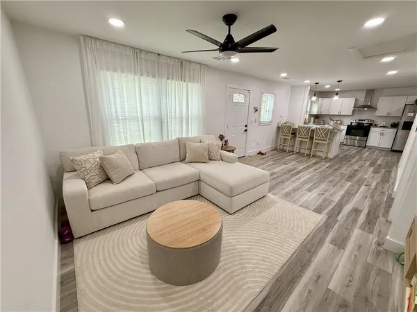 a living room with furniture and a large window