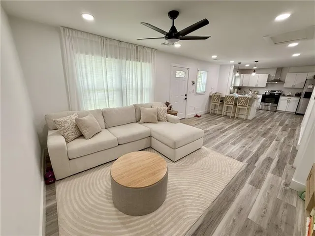 a living room with furniture and a large window