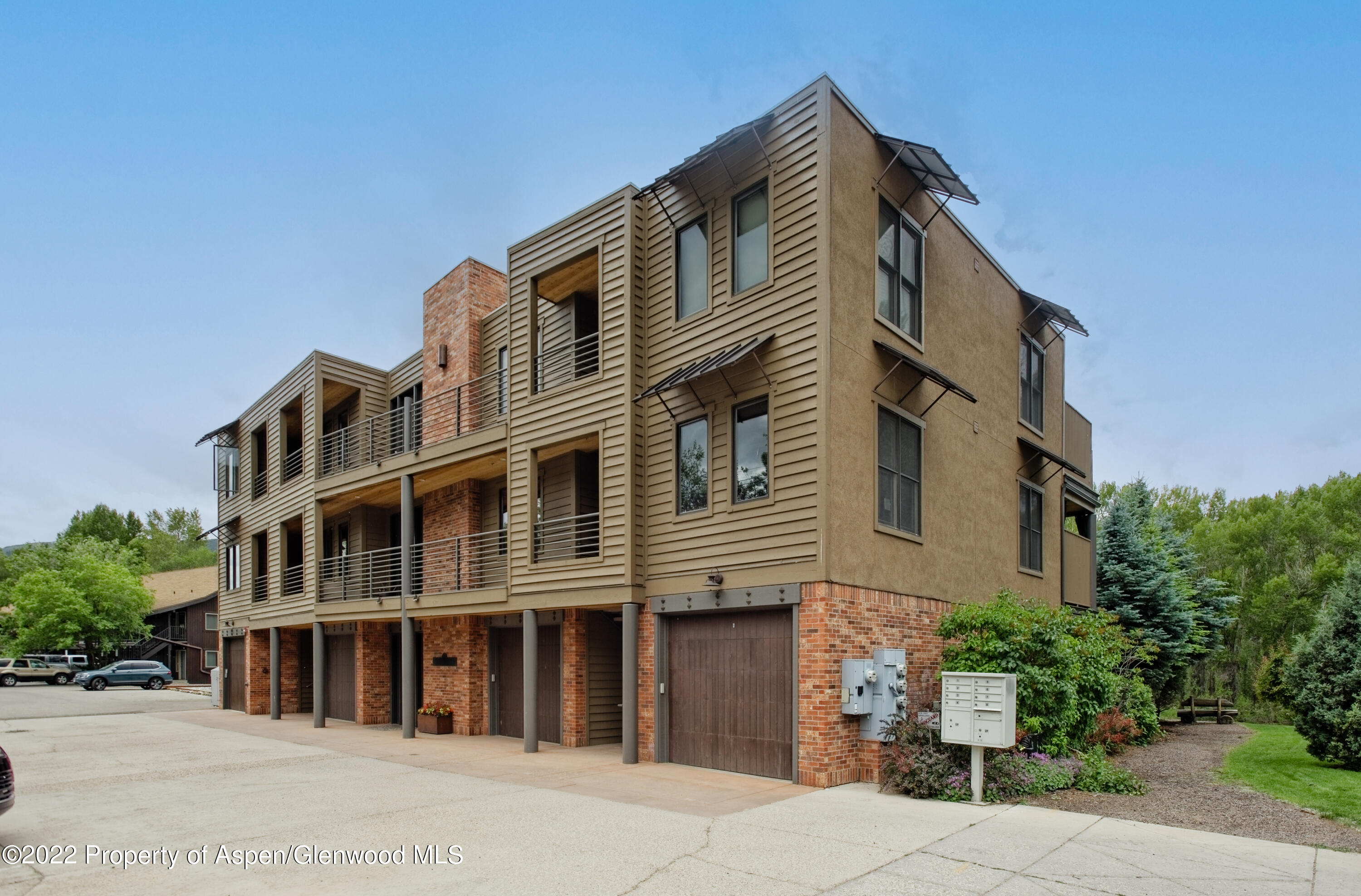 23272 2 Rivers Road, Unit 201 Basalt, CO 81621 - Photo 23 of 25 a front view of a building with a garden