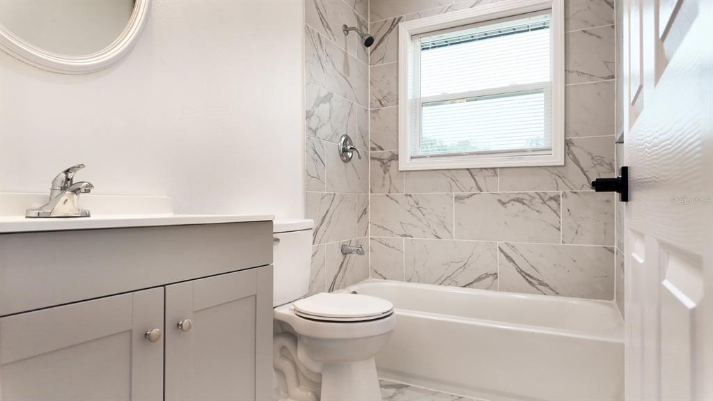 2607 Northeast 140th Street Citra, FL 32113 - Photo 17 of 36 a bathroom with a sink a toilet and a bathtub