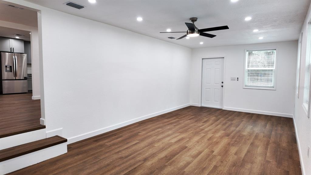 2607 Northeast 140th Street Citra, FL 32113 - Photo 24 of 36 a view of an empty room with wooden floor and a window