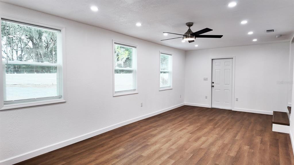 2607 Northeast 140th Street Citra, FL 32113 - Photo 25 of 36 a view of an empty room with wooden floor and a window