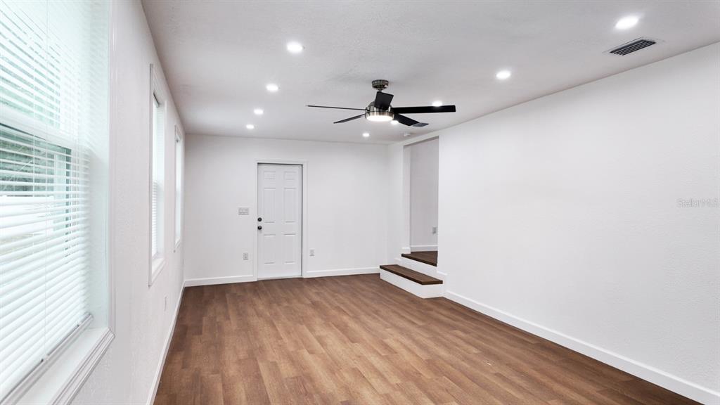 2607 Northeast 140th Street Citra, FL 32113 - Photo 26 of 36 a view of empty room with wooden floor and fan