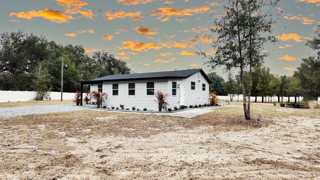 2607 Northeast 140th Street Citra, FL 32113 - Photo 4 of 36 a front view of a house with a yard