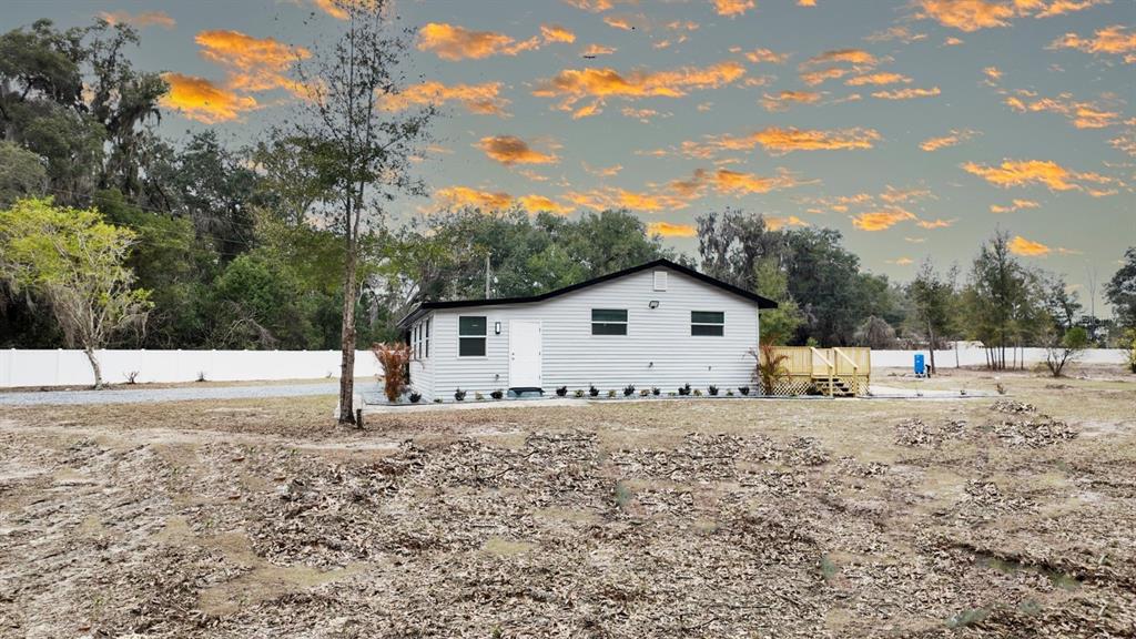 2607 Northeast 140th Street Citra, FL 32113 - Photo 8 of 36 a house with trees in the background