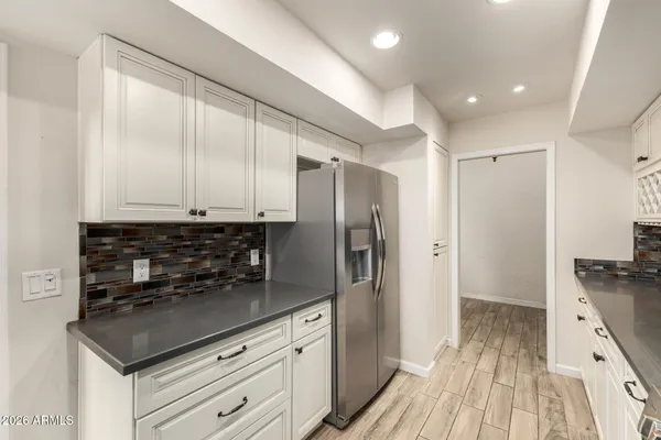 a kitchen with a refrigerator and a sink