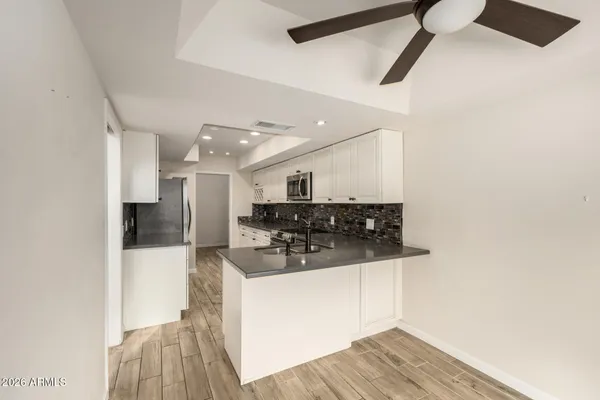 a kitchen with stainless steel appliances a refrigerator and a stove