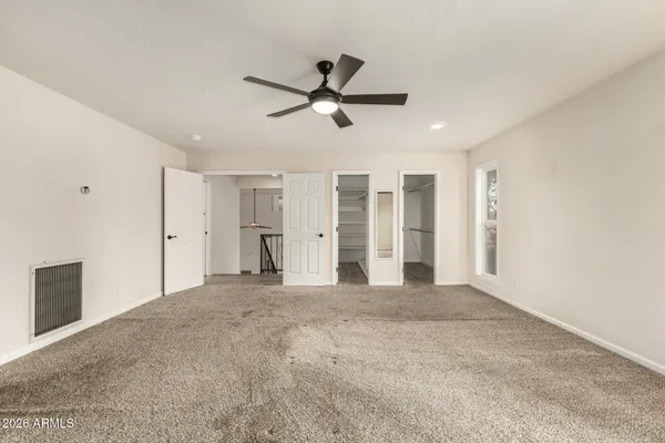 a view of walk in closet with empty racks