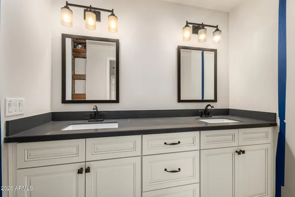 an empty room with closet and windows