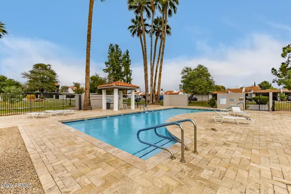 a view of a swimming pool with lounge chair