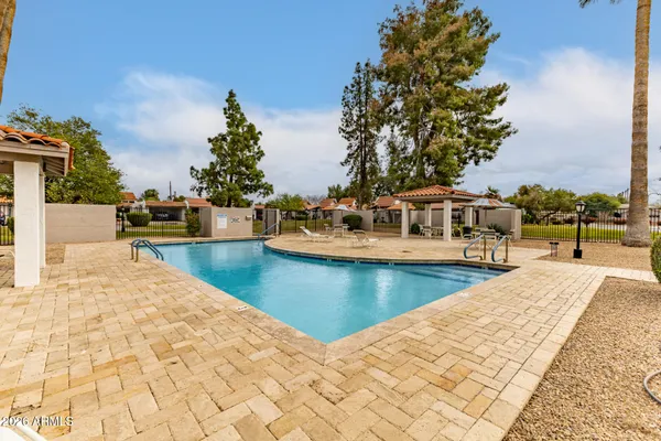 a view of a swimming pool with a patio