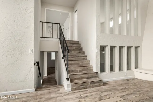 a view of entryway and hall with wooden floor