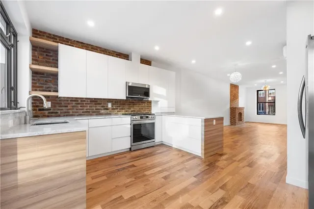 a view of a refrigerator in kitchen and wooden floor
