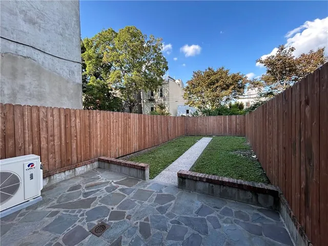 a bedroom with a bed a mirror and a window