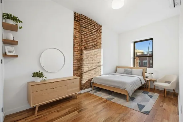a bedroom with a bed and a potted plant
