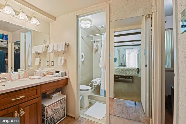 a en suite bathroom with a double vanity sink a mirror and a shower