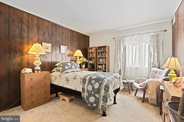 a bed room with a bed and a chair