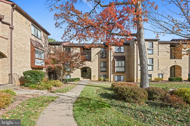 a front view of a building with a garden