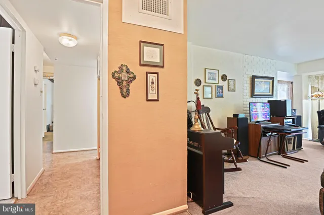 a view of a livingroom with workspace and a window