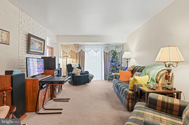 a view of a livingroom with workspace and a couch