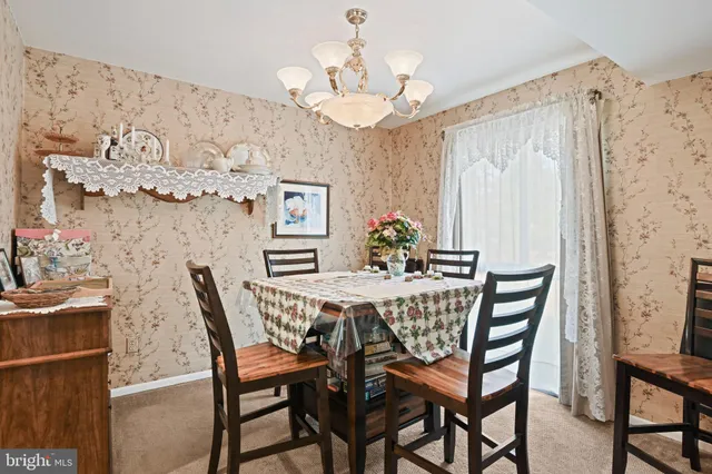 a view of a dining room with furniture and chandelier