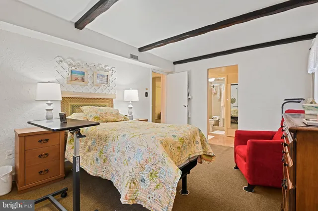 a bedroom with bed and wooden floor