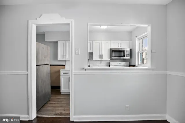 a view of a kitchen from the hallway