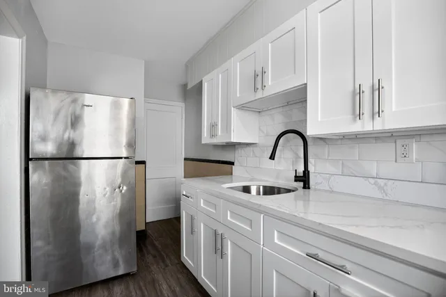 a kitchen with stainless steel appliances granite countertop a refrigerator sink and cabinets