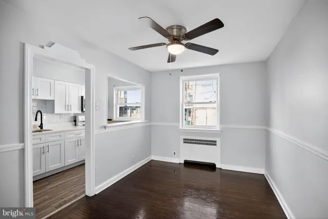 a view of a kitchen and an empty room