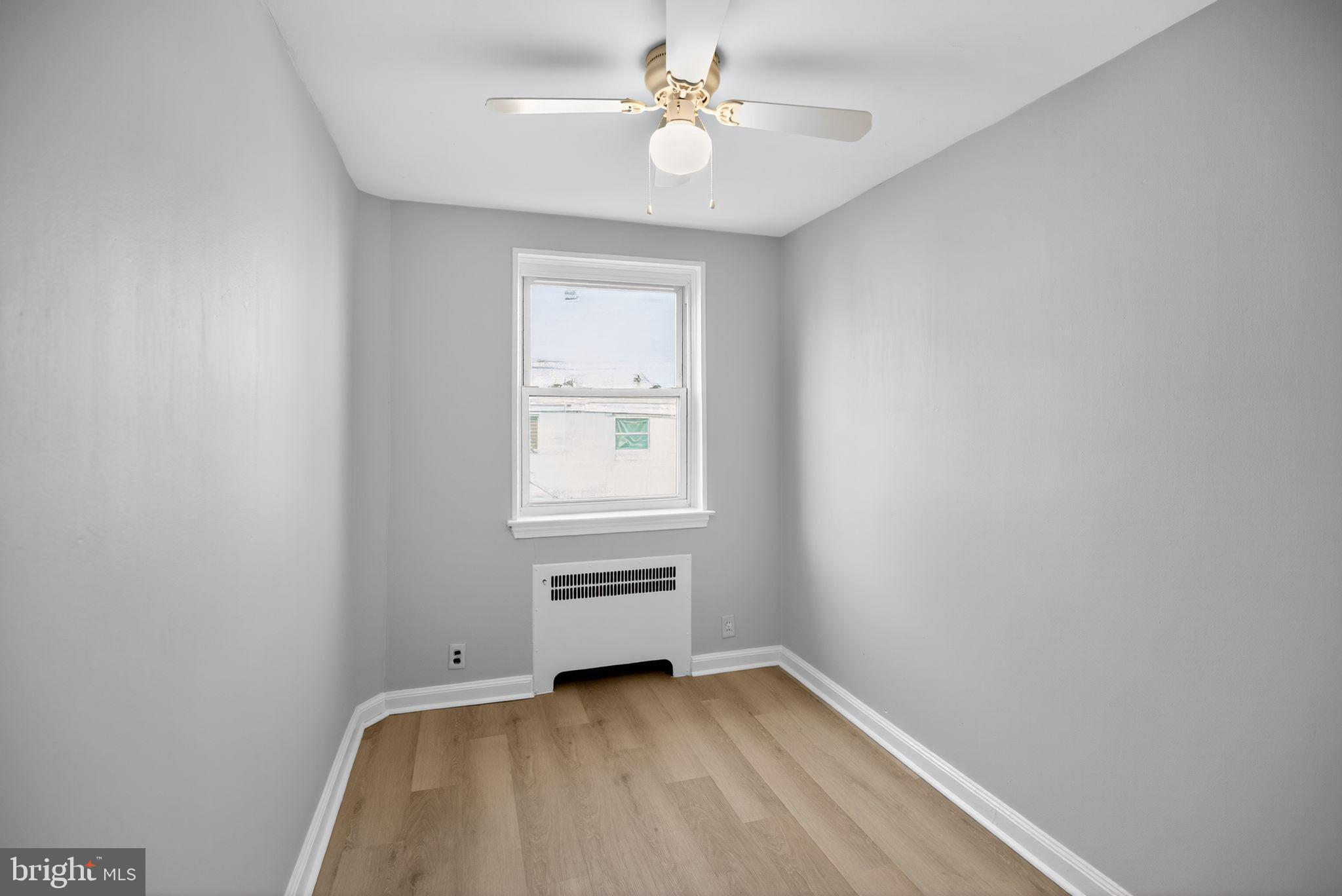 558 Snowden Road Upper Darby, PA 19082 - Photo 22 of 30 an empty room with a window and ceiling fan