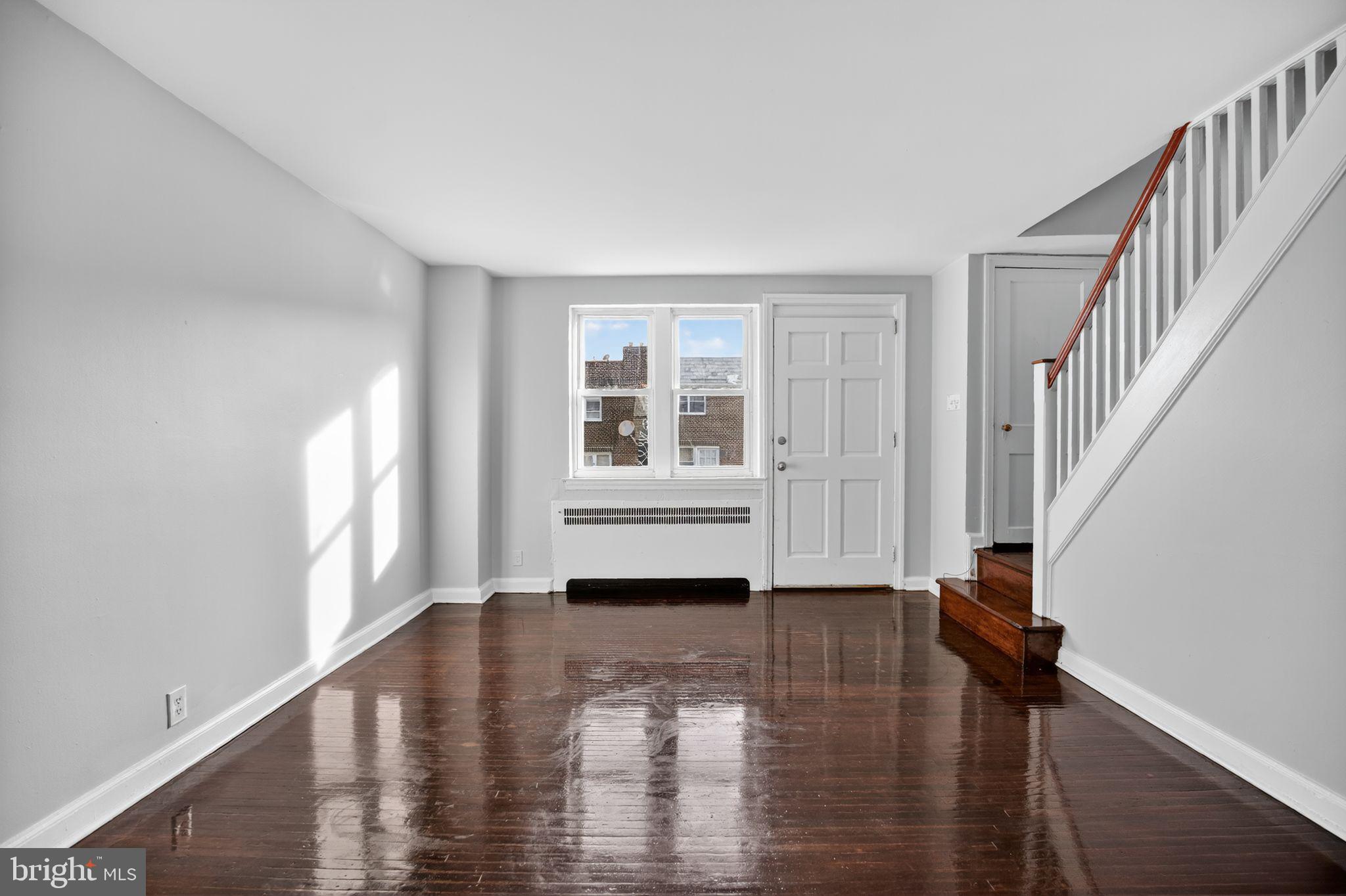 558 Snowden Road Upper Darby, PA 19082 - Photo 4 of 30 a view of a room with wooden floor and staircase